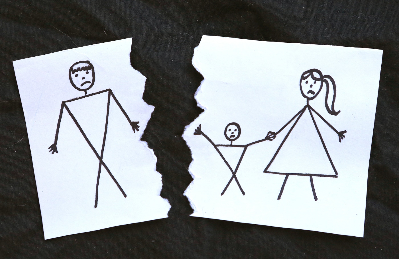 A childlike line illustration of a family being torn apart