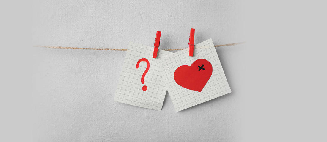 The biggest family law myths busted, a question mark and heart drawn on gridded paper pegged to a piece of string.